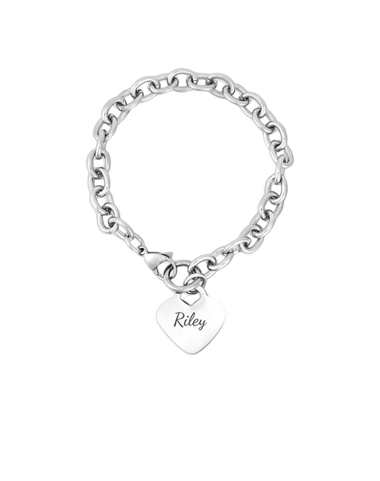 Silver bracelet with a heart-shaped tag on a light gray fabric background