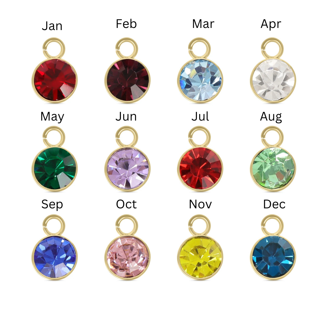 Jewelry charms with colorful crystals for each month of the year on a white background