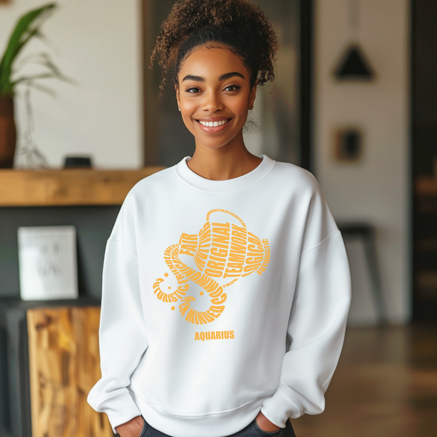 Person wearing a white sweatshirt with a yellow graphic design in a room setting