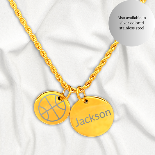 Gold necklace with basketball-themed pendant on a white fabric background