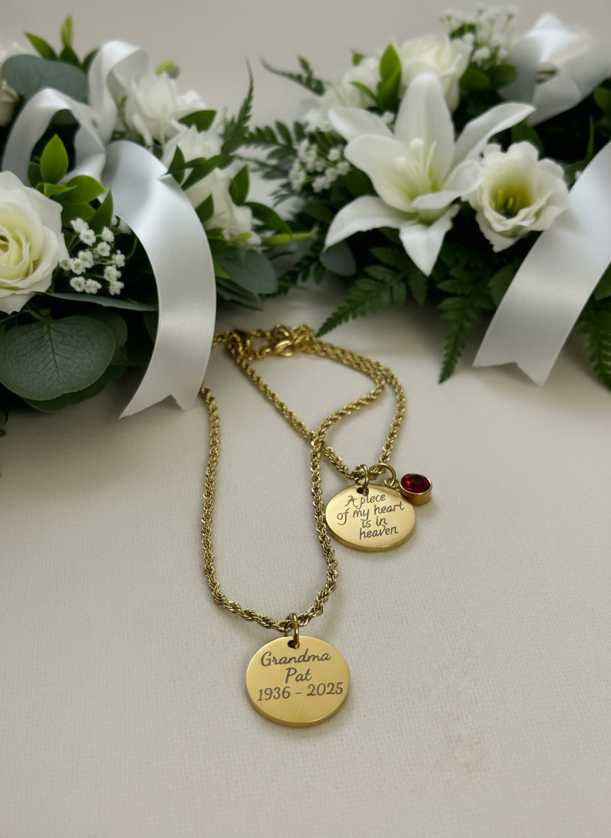 Gold necklace with engraved pendants on a light background