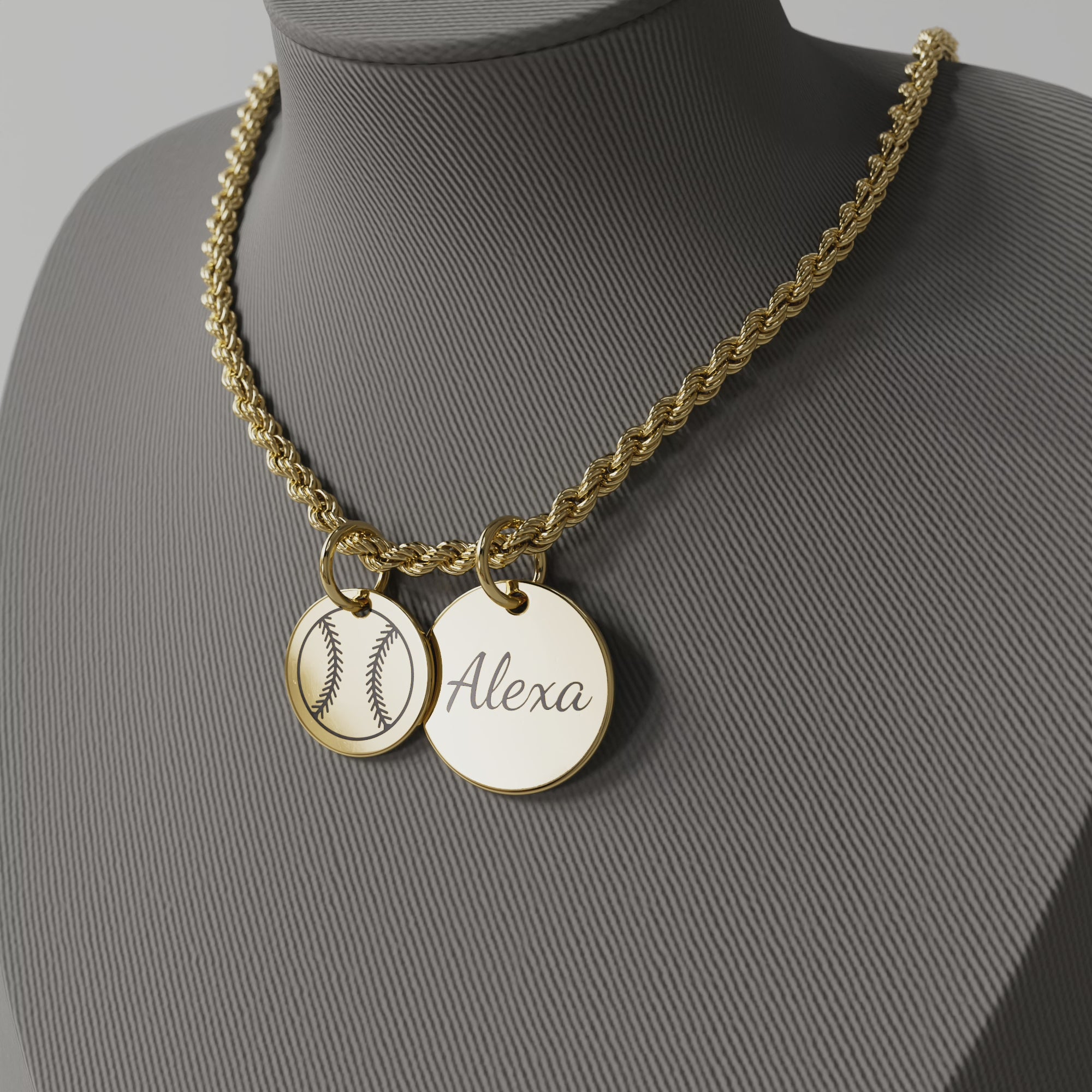 Video of rotating gold rope necklace with two circular charms, one with a softball, the other with the name Alexa